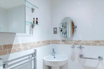 a white bathroom with a sink and a mirror at Cottage - Sleeps 5 - Hot Tub - Garden - Parking in Lancaster
