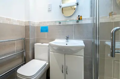 a bathroom with a toilet and a sink and a shower at Cottage - Sleeps 5 - Hot Tub - Garden - Parking in Lancaster