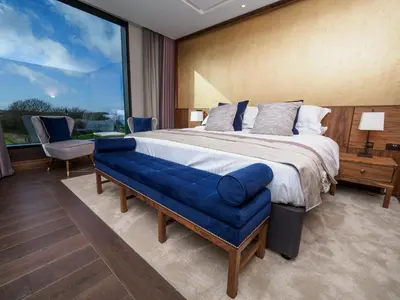 a bedroom with a large bed and a large window at The Hotel at Mill Farm in Kirkham