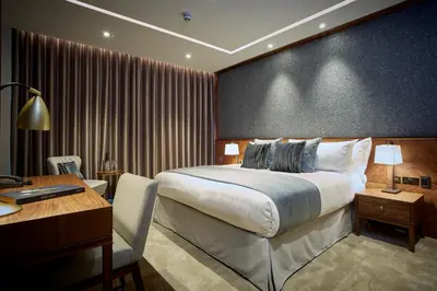 a hotel room with a bed and a desk and a computer at The Hotel at Mill Farm in Kirkham