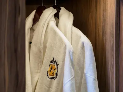 a white hoodie with a tiger on it hanging on a closet at The Hotel at Mill Farm in Kirkham