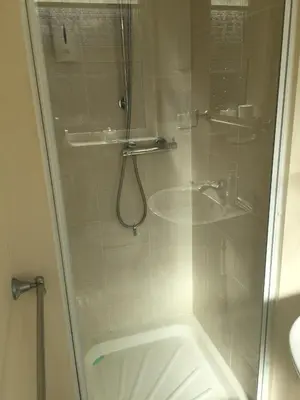 a shower with a glass door in a bathroom at Four Seasons Guest House in Blackpool