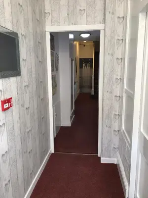 a hallway leading to a room with a hallway at Four Seasons Guest House in Blackpool