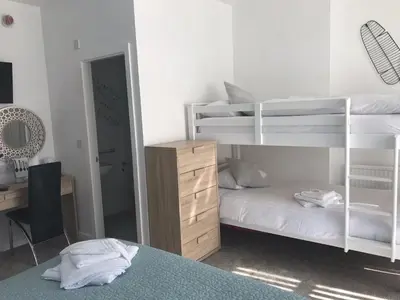 a bedroom with two bunk beds and a desk at Four Seasons Guest House in Blackpool