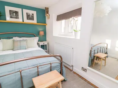 a bedroom with a bed and a window at 3 Poole End in Clitheroe