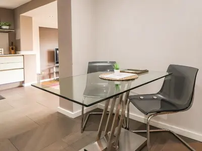 a glass table and chairs in a living room at Underfell in Carnforth