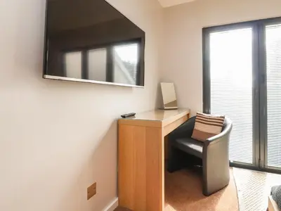 a room with a desk with a chair and a mirror at Underfell in Carnforth