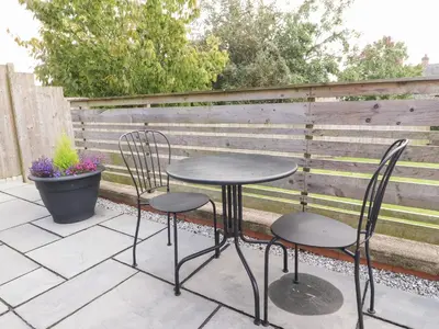 two chairs and a table on a patio at Underfell in Carnforth