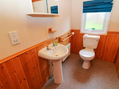 a bathroom with a toilet and a sink at The Cedars in Carnforth