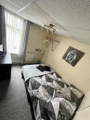 a bedroom with a bed in a room at Tudor Rose Hotel in Blackpool