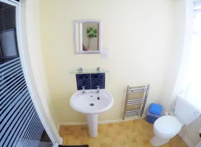 a bathroom with a sink and a toilet at Tudor Rose Hotel in Blackpool