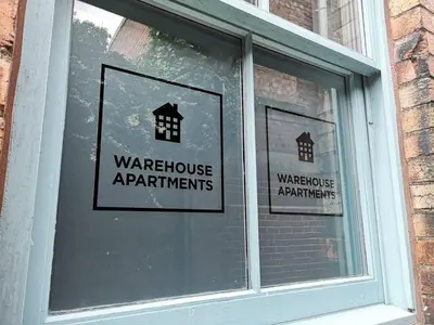 a window withwarning signs in the window of a building at Warehouse Apartments 1Bed Sleeps 2 Pets Welcome in Ulverston