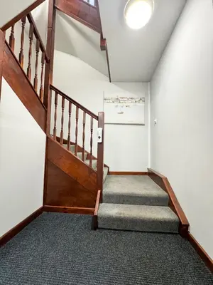 a staircase in a home with a wooden stair case at Warehouse Apartments 1Bed Sleeps 2 Pets Welcome in Ulverston
