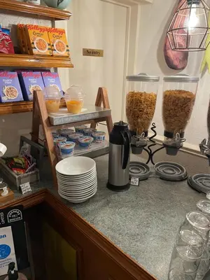 a kitchen counter with two containers of food and plates at Clifton Court Hotel in Blackpool