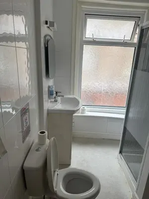 a bathroom with a toilet and a sink and a window at The Shores Hotel, Central Blackpool in Blackpool