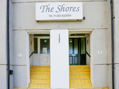 a store with two doors and a sign that reads the shops at The Shores Hotel, Central Blackpool in Blackpool