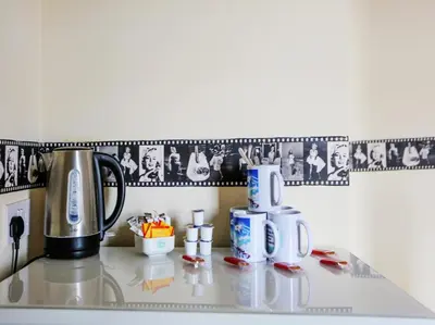 a counter top with a coffee pot and cups on it at The Shores Hotel, Central Blackpool in Blackpool
