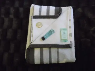 a white towel with a pen and money and a lighter at Atlantis Hotel in Blackpool
