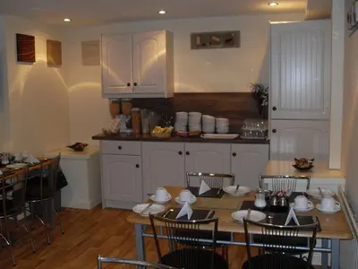 a kitchen with a table and chairs and a kitchen with a counter at Atlantis Hotel in Blackpool
