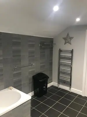 a bathroom with a tub and a star on the wall at Pleasure Beach House in Blackpool