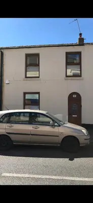 a silver car parked in front of a building at Pleasure Beach House in Blackpool