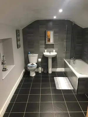a bathroom with a sink and a toilet and a bath tub at Pleasure Beach House in Blackpool