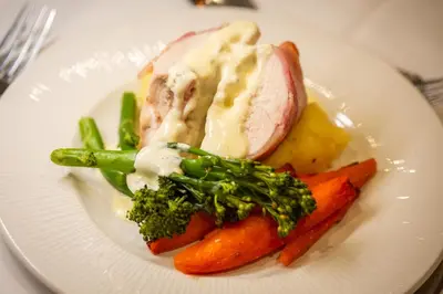 a plate of food with meat and vegetables on a table at Hotel Sheraton in Blackpool
