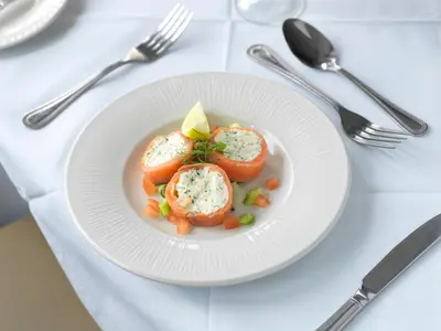a white plate of food with eggs on a table at Hotel Sheraton in Blackpool
