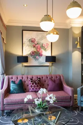 a purple couch in a living room with a painting at Hotel Sheraton in Blackpool