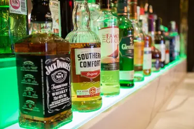 a row of bottles of alcohol on a shelf at Hotel Sheraton in Blackpool