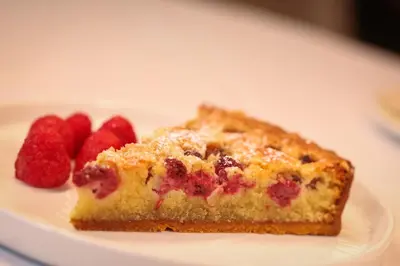 a piece of raspberry pie on a plate with raspberries at Hotel Sheraton in Blackpool