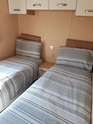 two beds sitting next to each other in a room at Port Haverigg Holiday Village in Millom