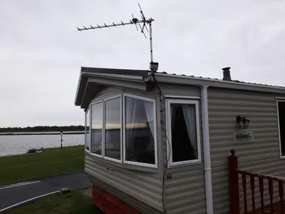 a mobile home with a view of the water at Port Haverigg Holiday Village in Millom