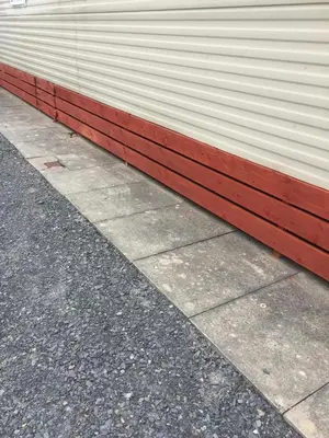 a white and red wall next to a sidewalk at Port Haverigg Holiday Village in Millom
