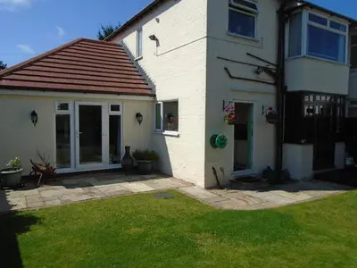 a white house with a patio and a yard at TEA in Liverpool - Private - Quiet - Ground Floor - En-suite - Walk-in-shower in Liverpool