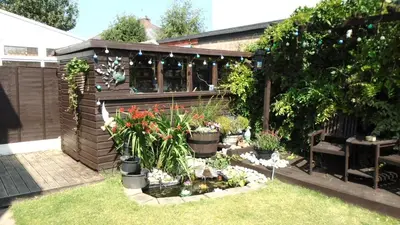a garden with flowers and plants in front of a building at TEA in Liverpool - Private - Quiet - Ground Floor - En-suite - Walk-in-shower in Liverpool