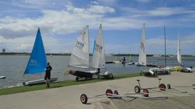a group of sail boats on the water with a woman at TEA in Liverpool - Private - Quiet - Ground Floor - En-suite - Walk-in-shower in Liverpool