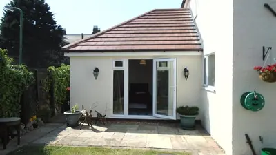 a small white house with a sliding glass door at TEA in Liverpool - Private - Quiet - Ground Floor - En-suite - Walk-in-shower in Liverpool