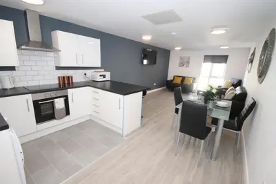 a kitchen and living room with a table and chairs at Fox Street Delight in Liverpool