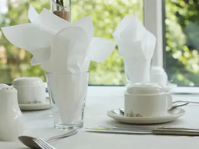 a table with a glass with white paper on it at The Liver View in Birkenhead