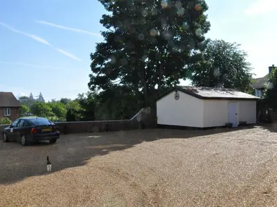 a car parked in a driveway next to a white garage at The Liver View in Birkenhead