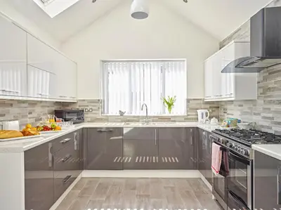 a kitchen with stainless steel appliances and a window at 88 Anfield Road in Liverpool