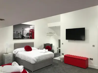 a bedroom with a bed and a flat screen tv at 88 Anfield Road in Liverpool