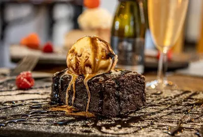 a chocolate dessert with a scoop of ice cream on top at The Strawbury Duck Inn in Darwen