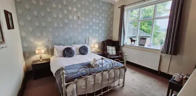 a bedroom with a bed and a window at The Strawbury Duck Inn in Darwen