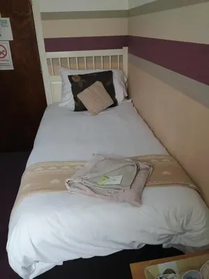 a bed with a towel on it in a room at The Garnett in Blackpool