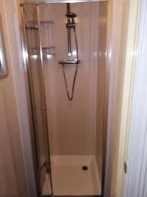 a shower with a glass door in a bathroom at The Garnett in Blackpool