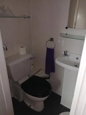 a small bathroom with a toilet and a sink at The Garnett in Blackpool