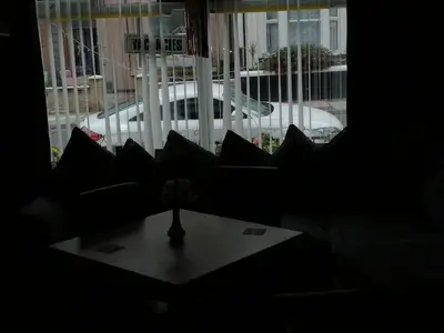 a living room with a couch and a table and a window at The Garnett in Blackpool