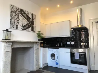 a kitchen with a washer and dryer in it at Fishergate ApartHotel 2 - City Centre Location in Preston